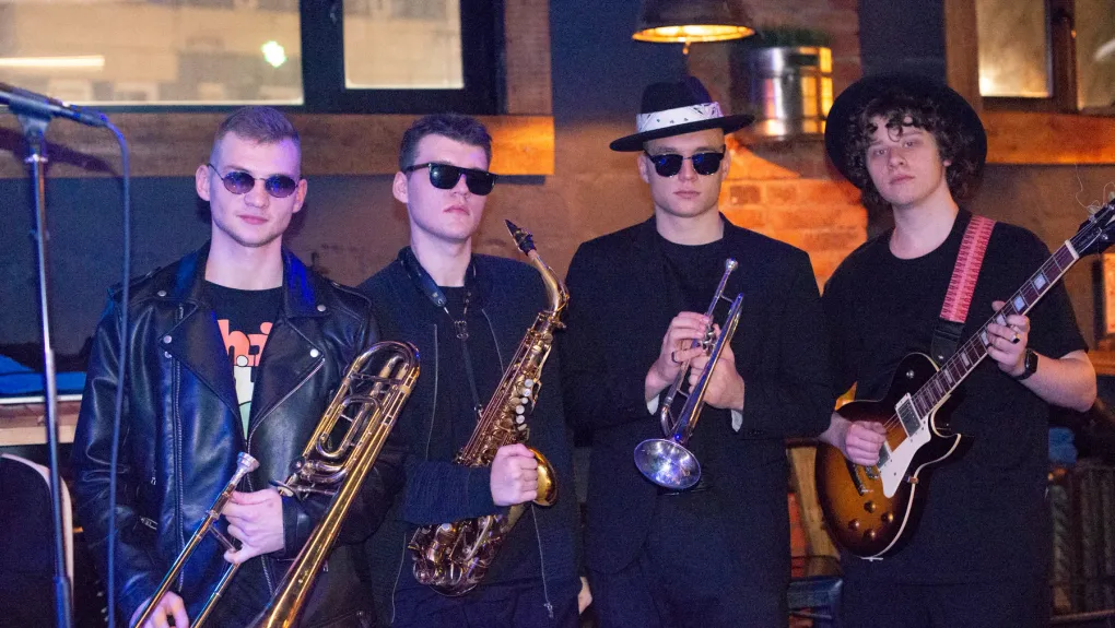 Tequila Funk Band standing with saxophone, trumpet and guitar during the Moscow era.